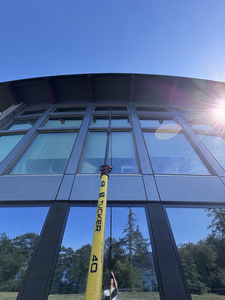 Cleaning tall exterior windows with a water-fed pole