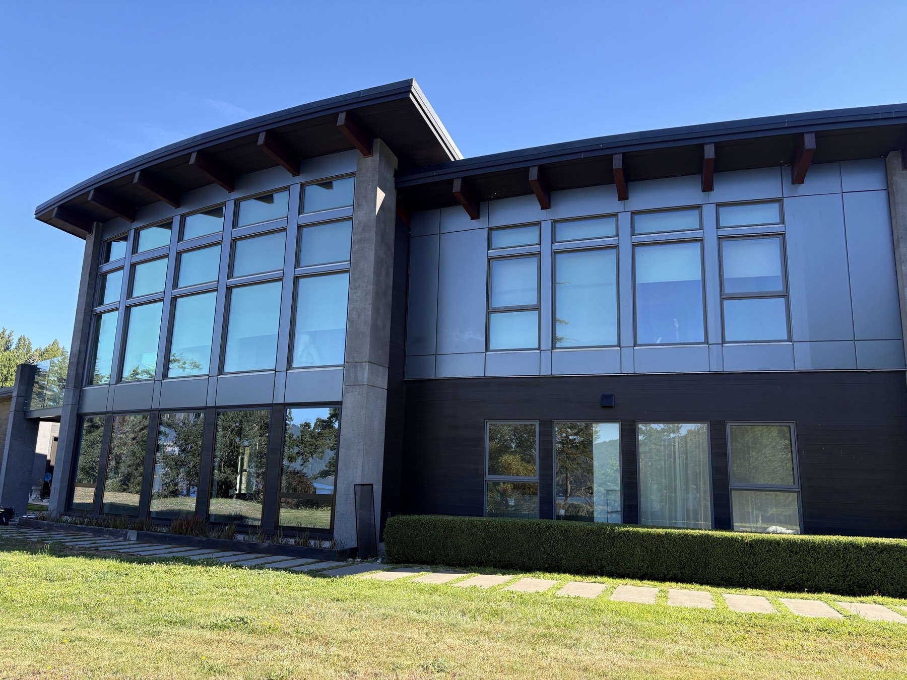 Freshly cleaned floor-to-ceiling windows on a modern building in Greater Victoria, BC